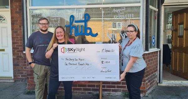 Youth group receiving a cheque from Skylight for £1,000