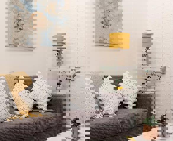 Grey sofa with cushions and lamp