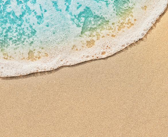 Top view of beach water meeting sand