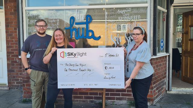 Youth group receiving a cheque from Skylight for £1,000