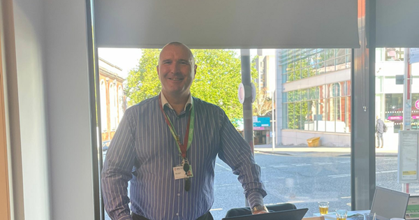 Funding Officer stood in front of an SHG lectern