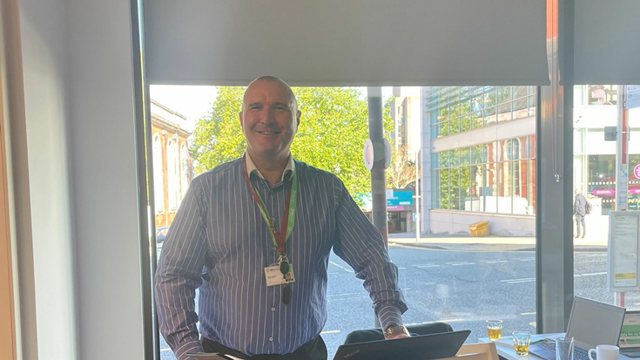 Funding Officer stood in front of an SHG lectern